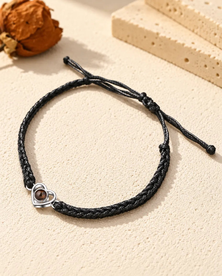 Armband mit Bild im Stein: offenes Herz aus 925er Sterlingsilber an schwarzem Flechtband auf hellem Gips
