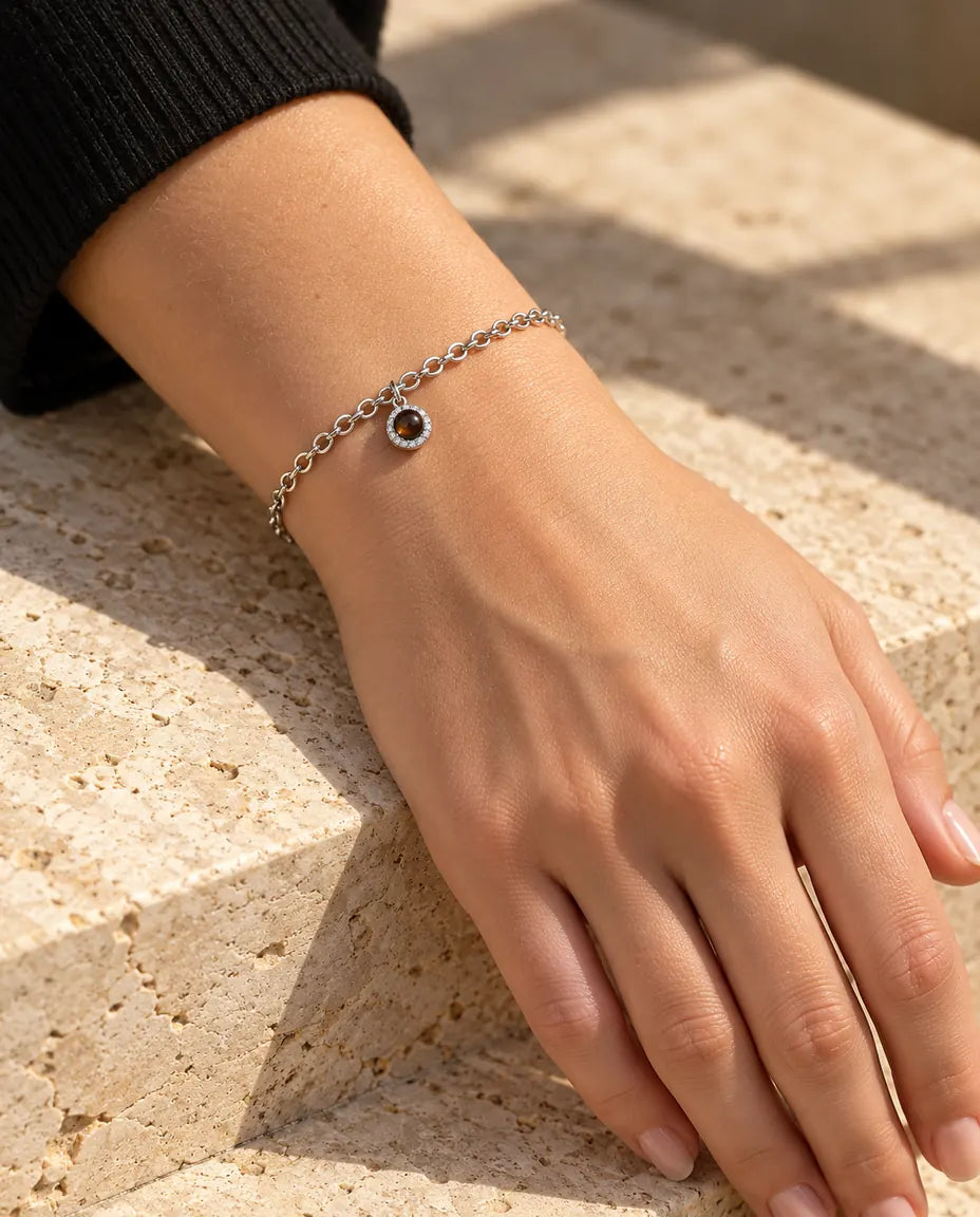 Frau trägt das silberfarbene Zirkonia-Armband mit Bild im Stein im warmen Sonnenlicht