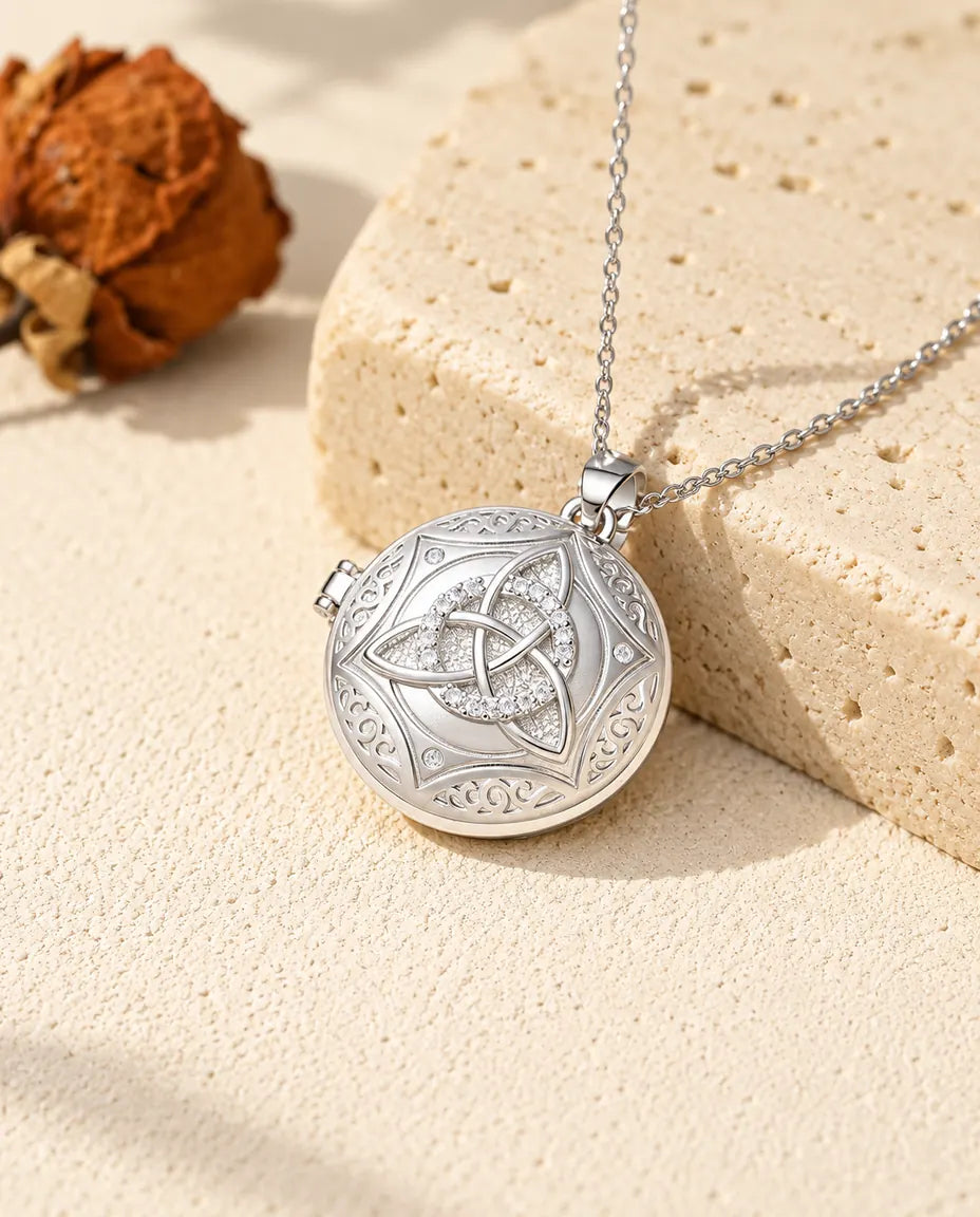 Personalisiertes rundes Foto-Medaillon mit keltischem Knoten in Silber und Zirkonia, an einen Travertinblock gelehnt